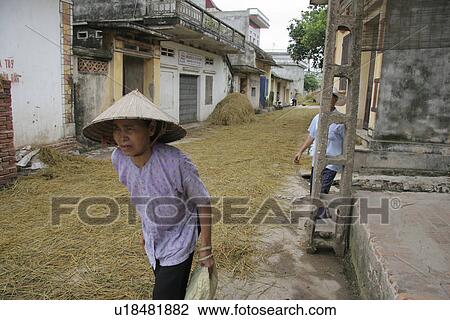 Stock Image - drying, person, rice, street, vietnam, people. Fotosearch