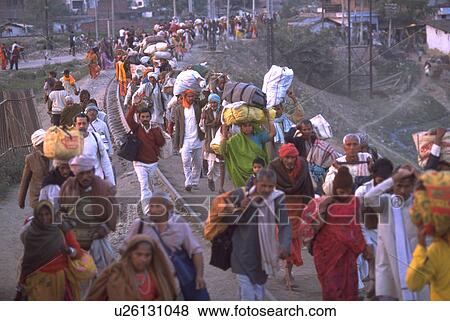 Stock Photo - embankment, peasant, railroad, walking, crowd, hindu. Fotosearch