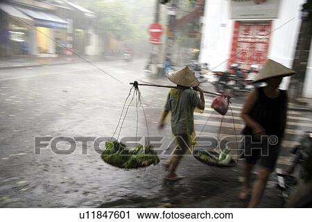 Stock Image - hanoi, person, day, rainy, vietnam, people. Fotosearch