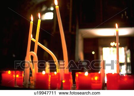 Stock Image - islesurla, burning, cathedral, notredamedesanges, interior, candles. Fotosearch