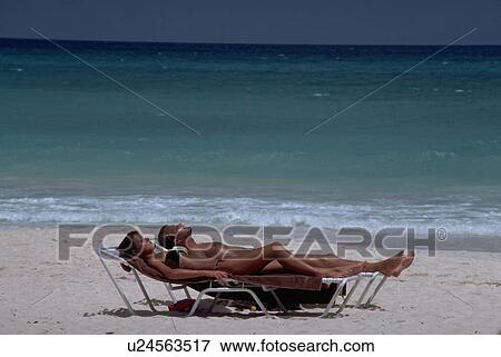 Stock Photo - lawrence, relaxes, st, saint, beach, couple. Fotosearch