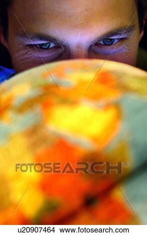 Picture - looking, globe, up, lit, male. Fotosearch
