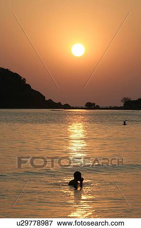 Stock Photo - palolem, person, sunset, india, sun, people. Fotosearch