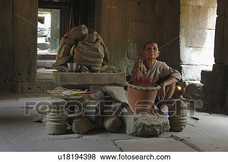 Stock Photo - people, shrine, cambodia, person, tree. Fotosearch
