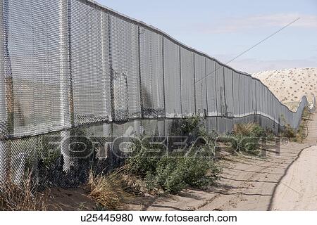 Stock Image - running, border, fence, usa, person, people. Fotosearch