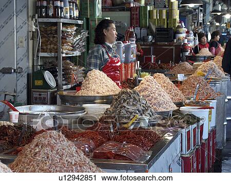 Stock Image - sale, people, korea, fish, person, food. Fotosearch