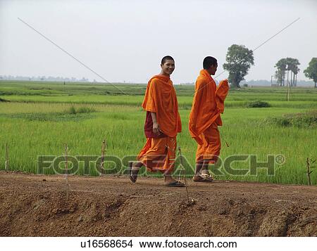 Picture - walking, person, monks, buddhist, cambodia, people. Fotosearch