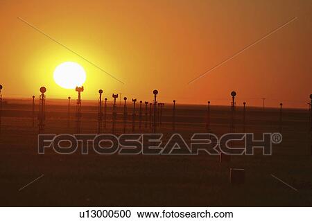Stock Image - 15, setting, lights, landing, behind, sun. Fotosearch