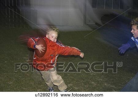 Stock Photograph - age, football, family, running, boy. Fotosearch