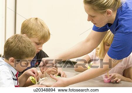 assisting, experiment, age, kids, teacher View Large Photo Image Picture - assisting, experiment, age, kids, teacher. Fotosearch