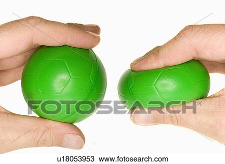 Stock Image - ball, hand, stress, green, squeezing, mans. Fotosearch