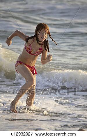 beach, girl, surf, through, running, young View Large Photo Image Stock Photo - beach, girl, surf, through, running, young. Fotosearch