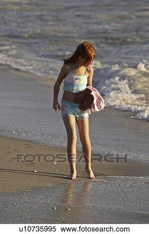 Stock Photography - beach, girl, surf, through, walking, young. Fotosearch