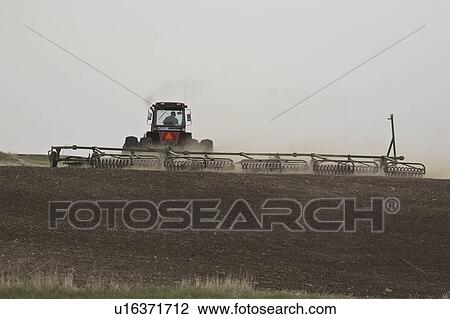 Stock Image - canada, working, saskatchewan, scenic, field, farmer. Fotosearch