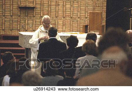 Stock Image - church, giving, catholic, alphonsus, communion, priest. Fotosearch