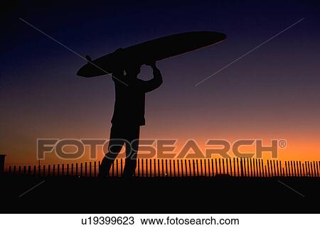 Stock Image - city, sunset, ocean, surfboard, carrying, surfer. Fotosearch