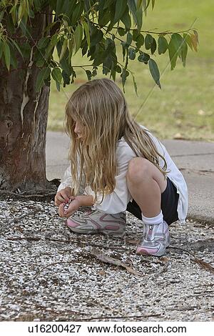 Stock Photo - course, girl, golf, stones, collecting, little. Fotosearch