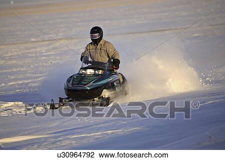 Stock Image - ditch, riding, filled, snow, skidoo, person. Fotosearch
