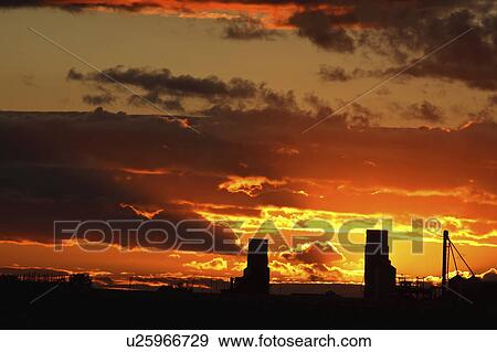 Stock Photo - elevators, behind, grain, saskatchewan, two, sunset. Fotosearch