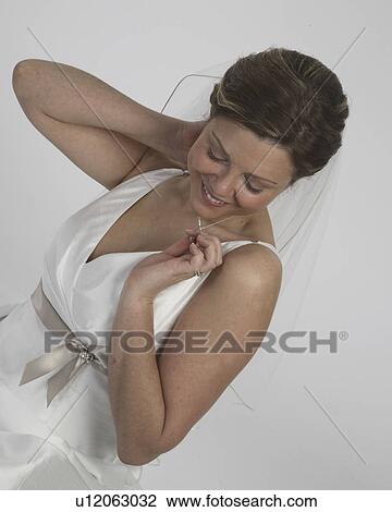 Stock Image - examining, wedding, necklace, bride. Fotosearch