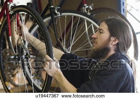 Stock Photo - express, inspecting, youth, wheel, bicycle, worker. Fotosearch