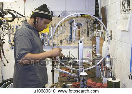 Stock Image - express, repairing, youth, wheel, bicycle, worker. Fotosearch