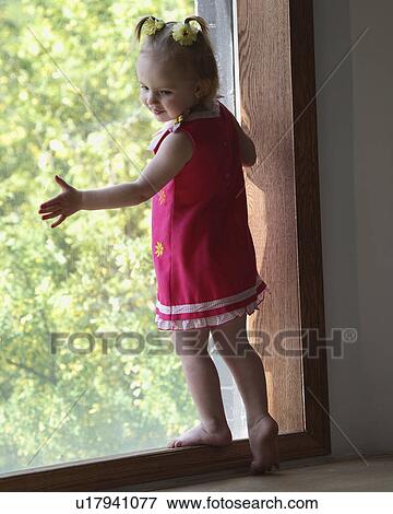 Stock Photo - girl, pretty, window, posing, little. Fotosearch