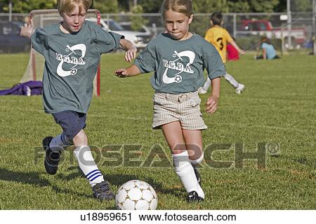 Stock Image - girls, soccer, competing, age, boys. Fotosearch