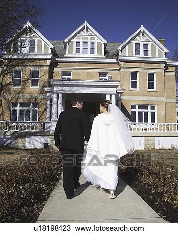 Stock Image - groom, building, walking, bride. Fotosearch