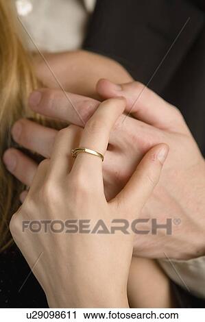 Stock Image - hands, ring, male, couple, holding. Fotosearch