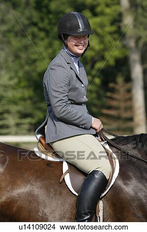Picture - horseshow, woman, horse, sitting, female, young. Fotosearch
