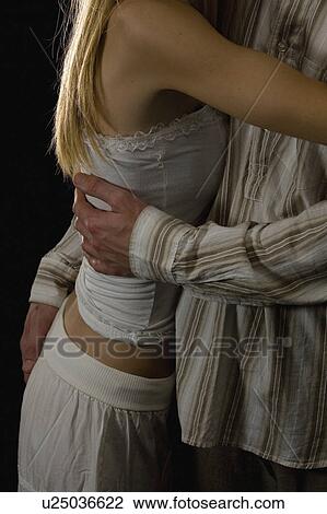 Stock Image - hugging, hug, holding, hands, couple. Fotosearch