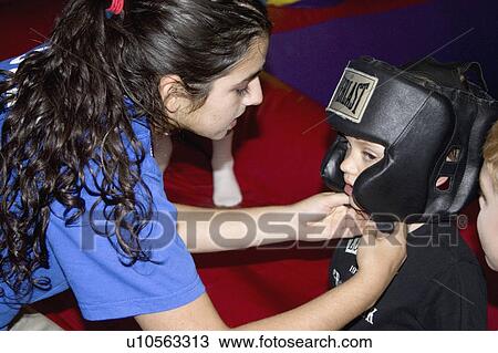 Stock Image - inflatable, boxing, up, pump, helmet, adjusting. Fotosearch
