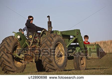 Stock Photo - kids, saskatchewan, dad, tractor, children. Fotosearch