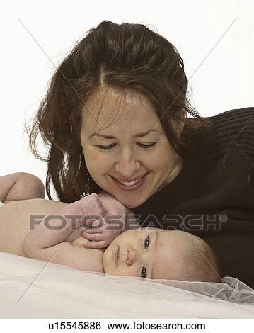 Stock Photograph - looking, mom, baby, down, mother. Fotosearch