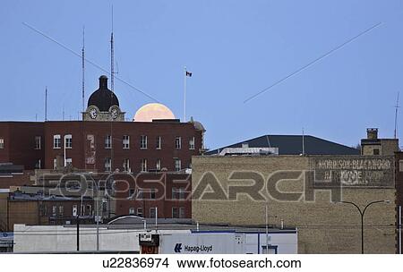 Picture - moon, building, city, rising, full. Fotosearch