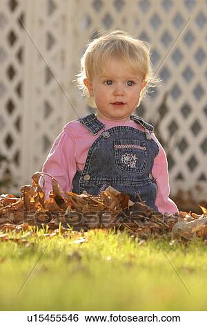Stock Photograph - moose, girl, poses, leaves, playing, young. Fotosearch