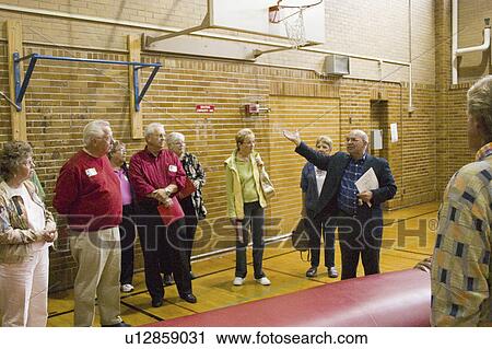 Stock Image - patrick, speaking, gym, school, high, principal. Fotosearch