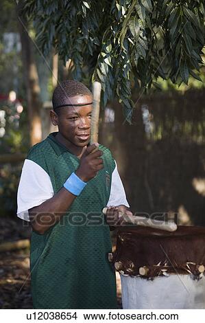 Picture - play, african, drum, holder, drummer, young. Fotosearch