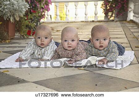 Stock Photograph - porch, babies, sheet, white, lying, triplet. Fotosearch
