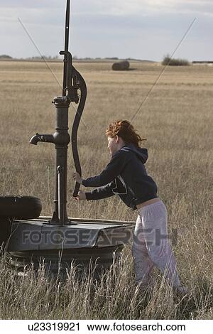 Stock Image - pump, girl, antique, get, tries, young. Fotosearch