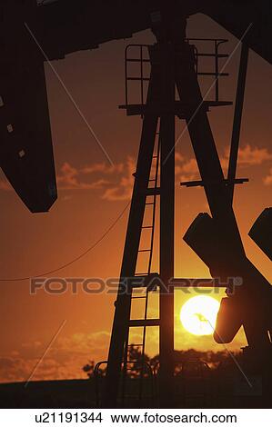 Picture - pump, setting, oil, mission, behind, sun. Fotosearch