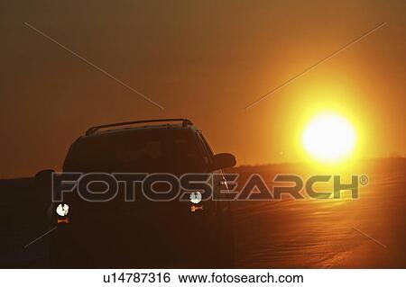 Stock Photograph - saskatchewan, backlit, scenic, sun, rising, vehicle. Fotosearch