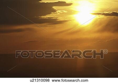 Stock Photo - scenic, partially, clouds, dust, hidden, sun. Fotosearch