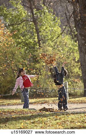scenic, tossing, leaves, autumn, up, siblings View Large Photo Image Stock Photo - scenic, tossing, leaves, autumn, up, siblings. Fotosearch