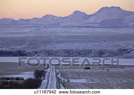 Stock Image - snow, mountains, highway, road, winter, rocky. Fotosearch