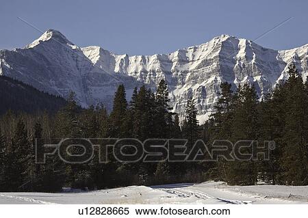 Stock Photography - snow, mountains, highway, road, winter, rocky. Fotosearch