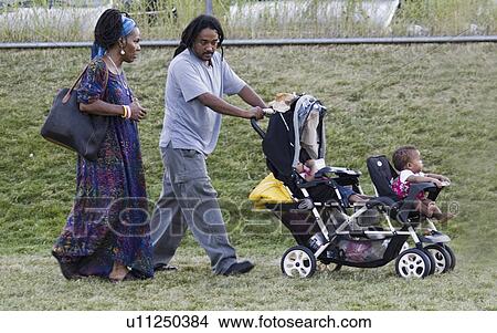 Picture - stroller, american, double, pushing, couple, african. Fotosearch