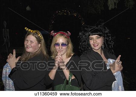 Stock Photo - treaters, innocent, trick, teens, devils, halloween. Fotosearch