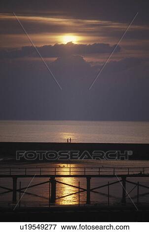 Stock Photo - walking, northern, people, denmark, germany, sunset. Fotosearch